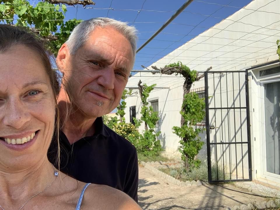 Happy couple in front of their newly purchased villa